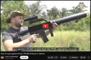 A man holding an air rifle in his hand.