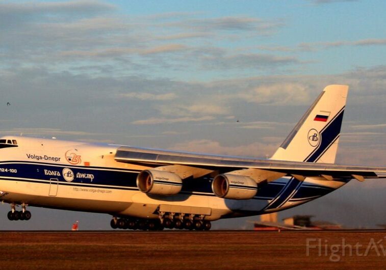 A large airplane sitting on top of an airport runway.