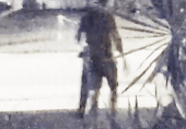 A blurry image of a man standing in the street.