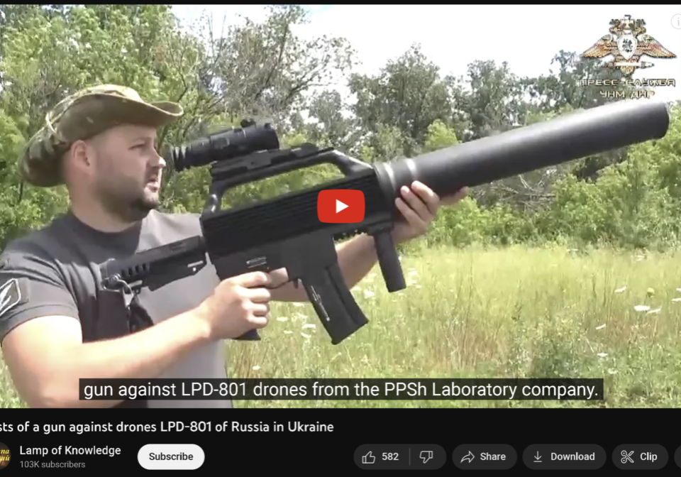 A man holding an air rifle in his hand.