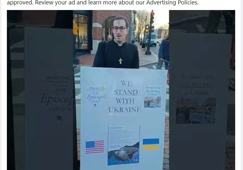 A person standing in front of an advertisement.